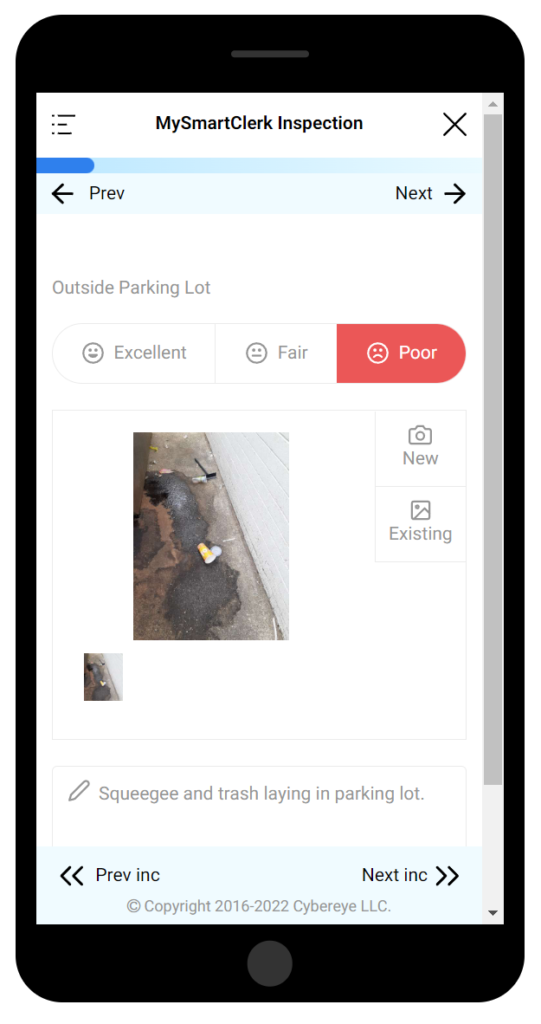 Mobile phone showing inspection of parking lot, with image, rating, and description.